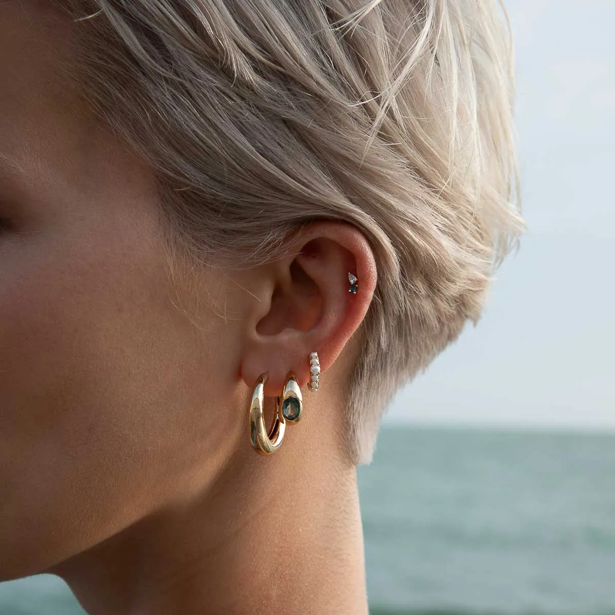 Blue Topaz Dome Hoops in Gold